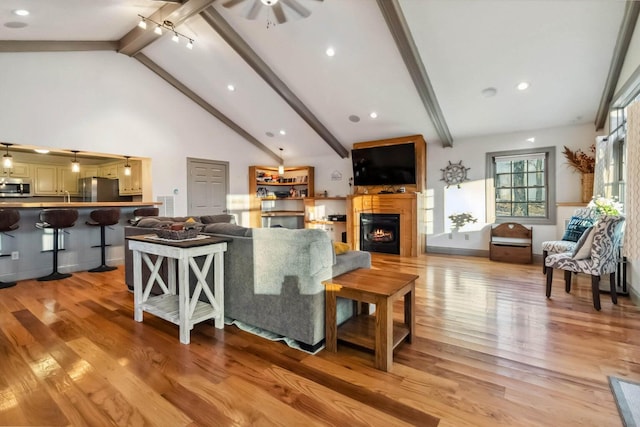 675 Indian Cave Subdivision Rd, Monticello, KY 42633 - living room featuring light wood-style floors, ceiling fan, a warm lit fireplace, and recessed lighting