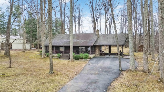 675 Indian Cave Subdivision Rd, Monticello, KY 42633 - view of front of house featuring roof with shingles, asphalt driveway, a porch, a carport, and a front lawn