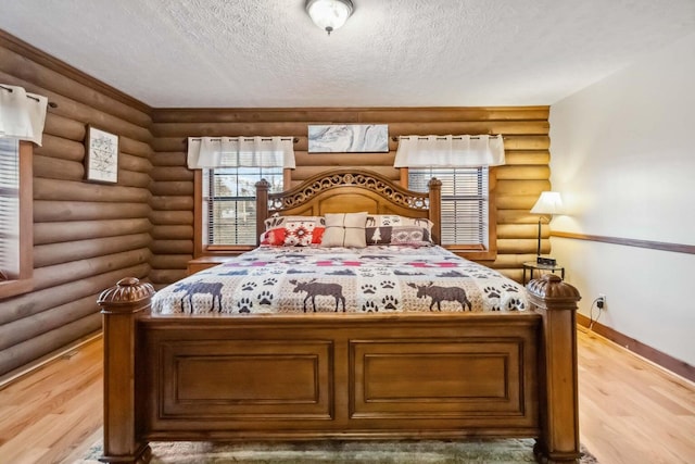 675 Indian Cave Subdivision Rd, Monticello, KY 42633 - bedroom featuring rustic walls, light wood-style flooring, a textured ceiling, and baseboards