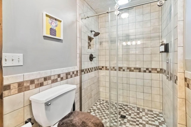 675 Indian Cave Subdivision Rd, Monticello, KY 42633 - bathroom with a stall shower, toilet, tile walls, and wainscoting