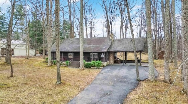 675 Indian Cave Subdivision Rd, Monticello, KY 42633 - view of front of property featuring asphalt driveway, a shingled roof, a porch, a carport, and a front lawn