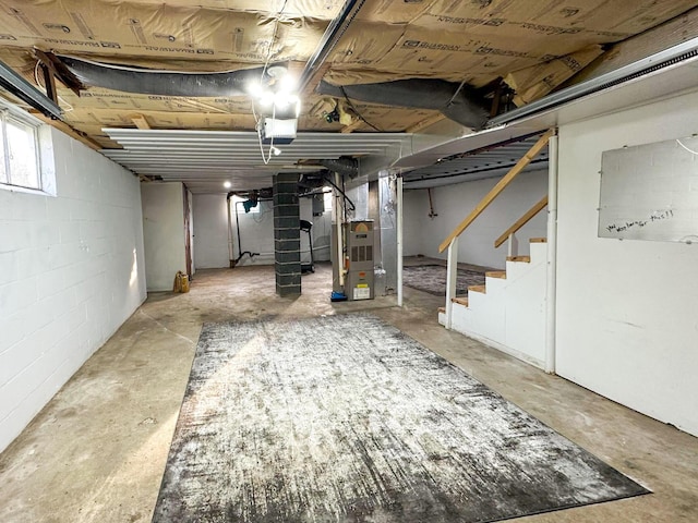 247 Mt Sterling Ave, Flemingsburg, KY 41041 - below grade area with heating unit, concrete block wall, and stairway