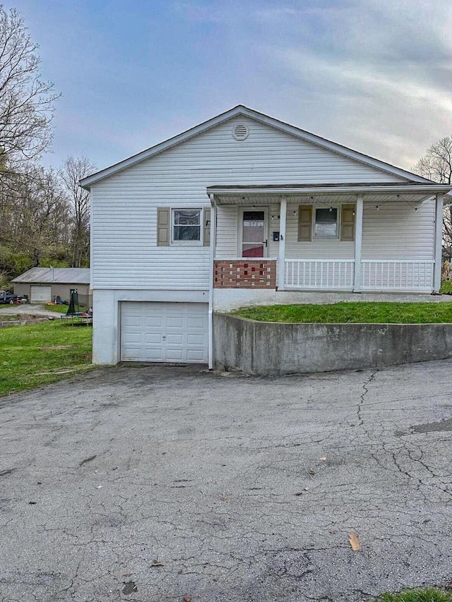 247 Mt Sterling Ave, Flemingsburg, KY 41041 - view of front facade featuring covered porch, driveway, and a garage