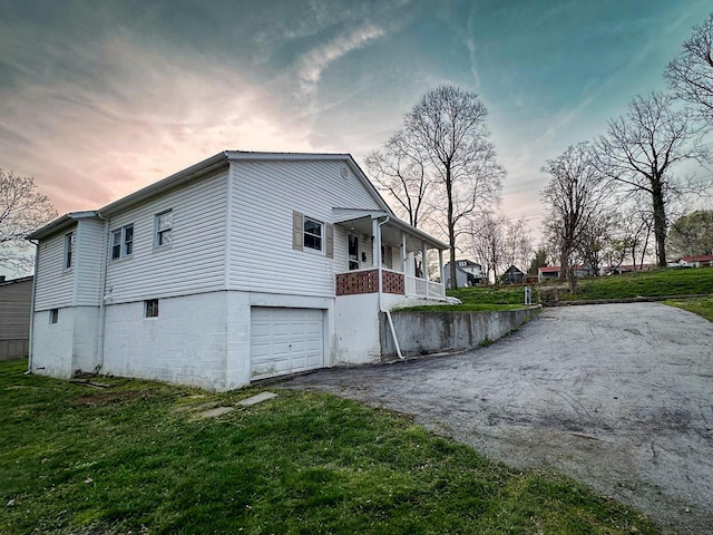 247 Mt Sterling Ave, Flemingsburg, KY 41041 - property exterior at dusk with driveway, an attached garage, a lawn, and a porch
