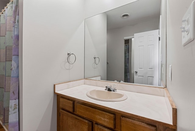 bathroom with vanity and curtained shower