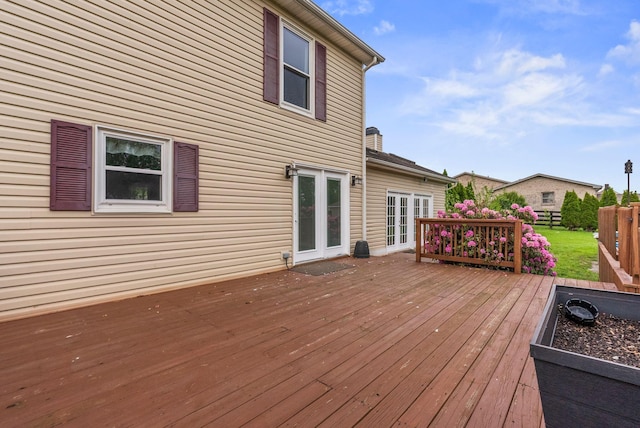 wooden deck featuring fence and french doors