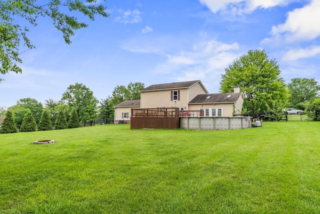 view of yard featuring a covered pool and a wooden deck