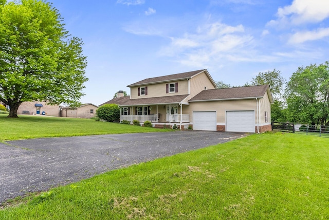view of front of property featuring a porch, a garage, and driveway