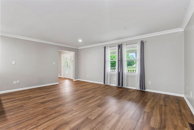 empty room featuring ornamental molding, baseboards, wood finished floors, and recessed lighting