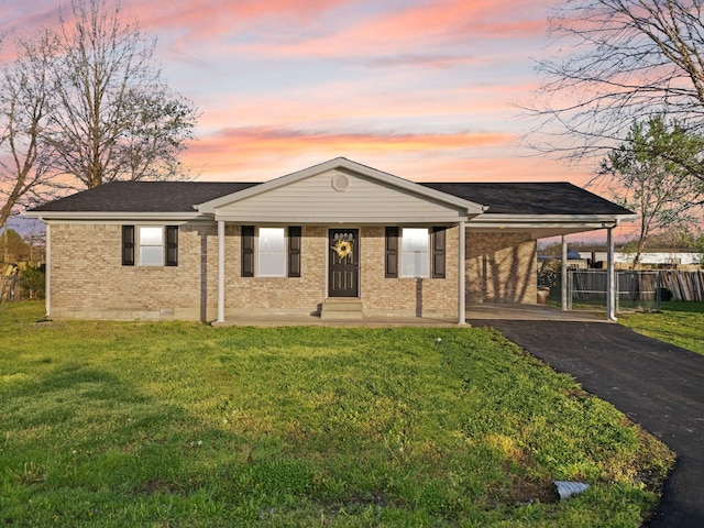 80 Westview Dr, Stanton, KY 40380 - ranch-style home with a carport, aphalt driveway, brick siding, a yard, and fence