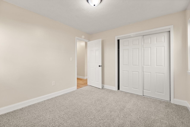 80 Westview Dr, Stanton, KY 40380 - unfurnished bedroom with a textured ceiling, a closet, light colored carpet, and baseboards