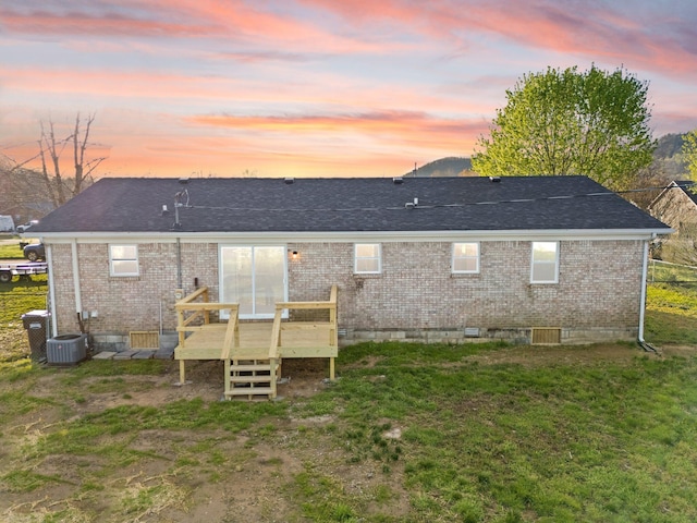 80 Westview Dr, Stanton, KY 40380 - back of property at dusk featuring central air condition unit, a lawn, roof with shingles, brick siding, and a deck