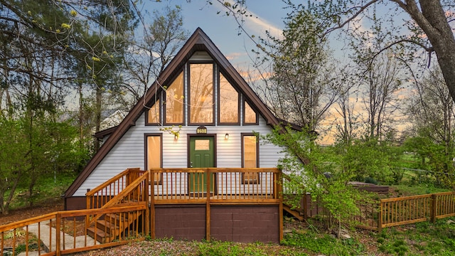 250 Dogwalk Rd, Paint Lick, KY 40461 - back of property at dusk with stairway and a deck