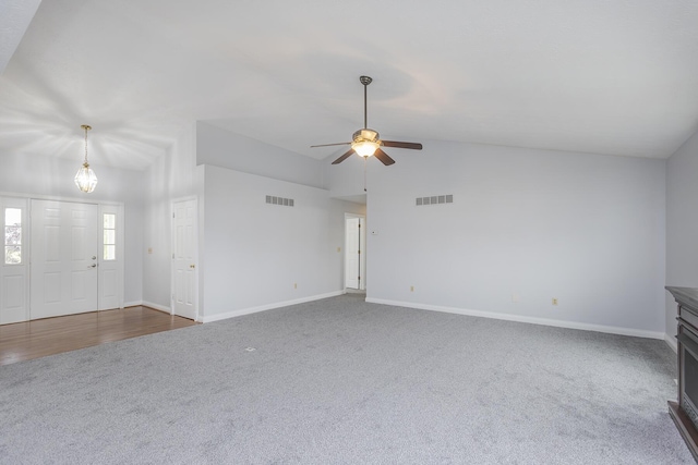256 Sutton Ln, Lancaster, KY 40444 - unfurnished living room featuring dark carpet, a ceiling fan, vaulted ceiling, and baseboards