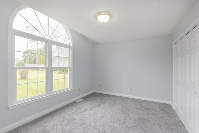 256 Sutton Ln, Lancaster, KY 40444 - unfurnished bedroom with carpet, baseboards, a closet, and vaulted ceiling
