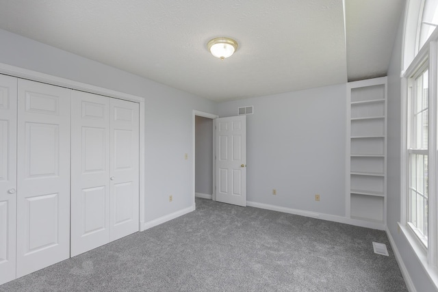256 Sutton Ln, Lancaster, KY 40444 - unfurnished bedroom featuring carpet flooring, multiple windows, baseboards, a closet, and a textured ceiling