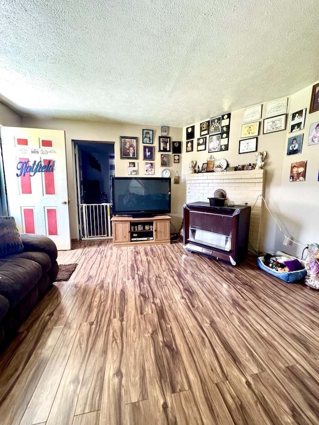 112 Exeter Ave, Middlesboro, KY 40965 - living room featuring a textured ceiling and wood finished floors
