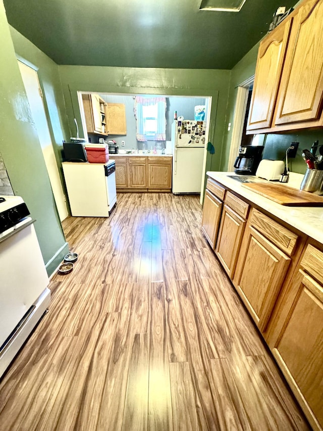 112 Exeter Ave, Middlesboro, KY 40965 - kitchen with white appliances, light wood-type flooring, light countertops, and light brown cabinetry