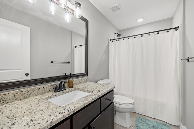 full bath featuring visible vents, toilet, curtained shower, and vanity