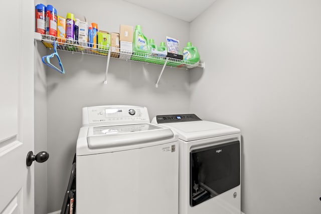 laundry area with washing machine and clothes dryer and laundry area
