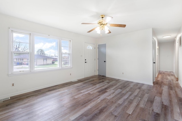 2429 Mirahill Dr, Lexington, KY 40509 - unfurnished living room featuring visible vents, ceiling fan, wood finished floors, and baseboards
