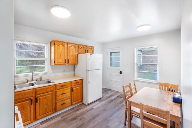 2429 Mirahill Dr, Lexington, KY 40509 - kitchen with a sink, light countertops, light wood-type flooring, freestanding refrigerator, and brown cabinets