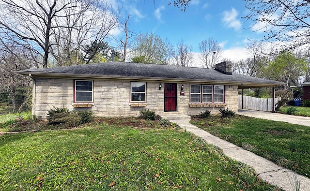 ranch-style home with concrete driveway, stone siding, a front yard, a carport, and a chimney