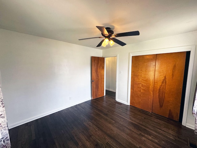 unfurnished bedroom featuring a ceiling fan, dark wood-type flooring, baseboards, and visible vents