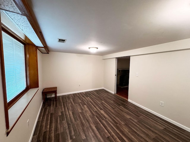 interior space featuring wood finished floors, baseboards, and visible vents