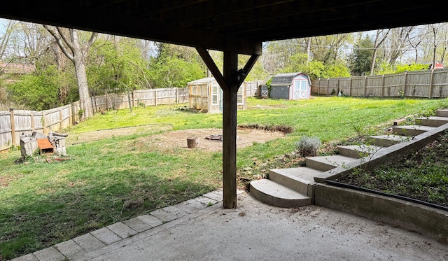 view of yard with a fenced backyard, a shed, an outdoor structure, and a patio