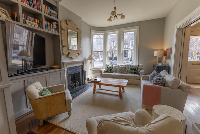 261 N Broadway, Lexington, KY 40507 - living room featuring a premium fireplace, wood finished floors, and a chandelier
