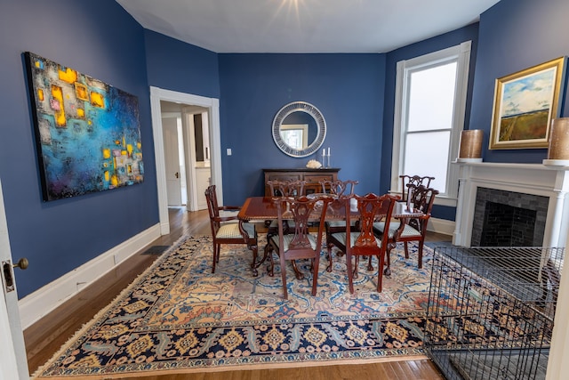261 N Broadway, Lexington, KY 40507 - dining space with wood finished floors, baseboards, and a fireplace