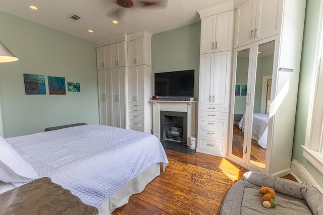 261 N Broadway, Lexington, KY 40507 - bedroom featuring dark wood-style flooring, recessed lighting, and a fireplace