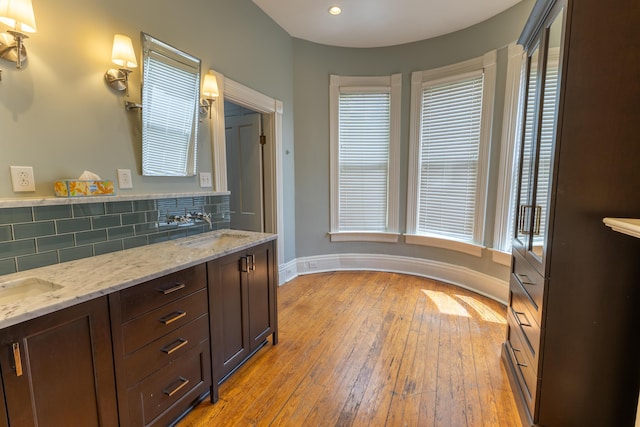 261 N Broadway, Lexington, KY 40507 - bathroom with decorative backsplash, baseboards, hardwood / wood-style floors, plenty of natural light, and recessed lighting