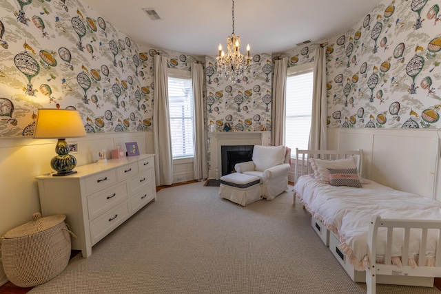 261 N Broadway, Lexington, KY 40507 - bedroom with wallpapered walls, a wainscoted wall, a chandelier, a fireplace with flush hearth, and light colored carpet