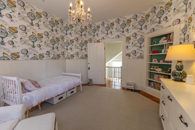 261 N Broadway, Lexington, KY 40507 - bedroom featuring wallpapered walls, a wainscoted wall, a chandelier, wood finished floors, and a decorative wall
