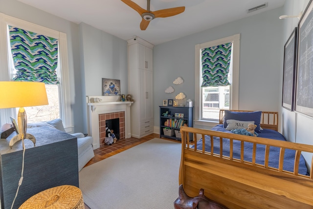 261 N Broadway, Lexington, KY 40507 - bedroom featuring multiple windows, a fireplace, ceiling fan, and baseboards
