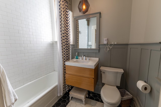 261 N Broadway, Lexington, KY 40507 - bathroom featuring vanity, tile patterned flooring, a decorative wall, toilet, and tub / shower combination