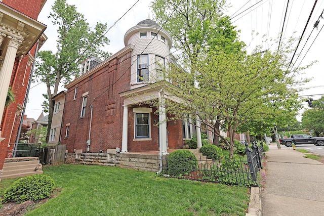 261 N Broadway, Lexington, KY 40507 - view of side of home featuring brick siding and a lawn
