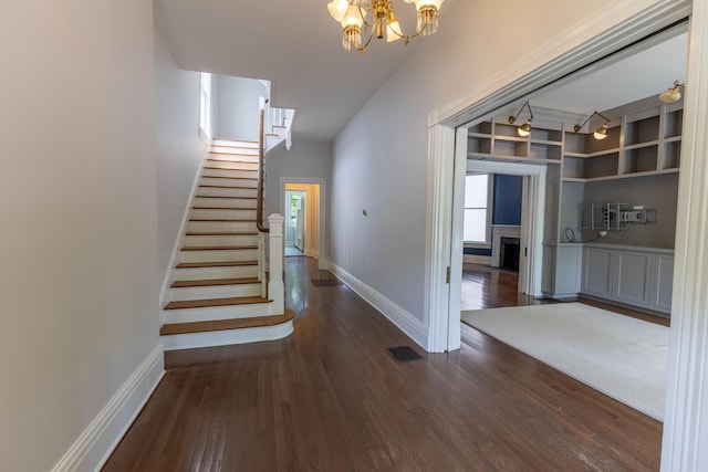 261 N Broadway, Lexington, KY 40507 - staircase with wood finished floors, a chandelier, and baseboards