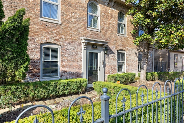 italianate house with brick siding and fence
