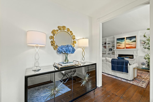 office space with a fireplace, built in features, and hardwood / wood-style flooring