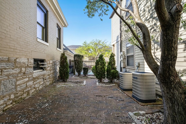 view of yard with central AC unit, fence, and a patio area