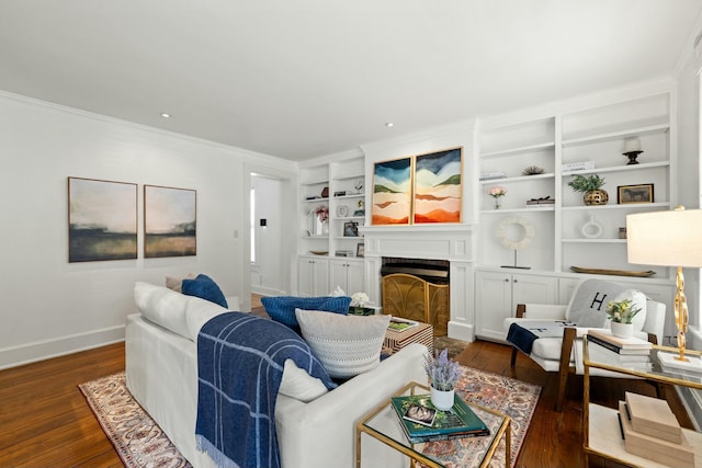 living room with dark wood-style floors, baseboards, a fireplace, and crown molding