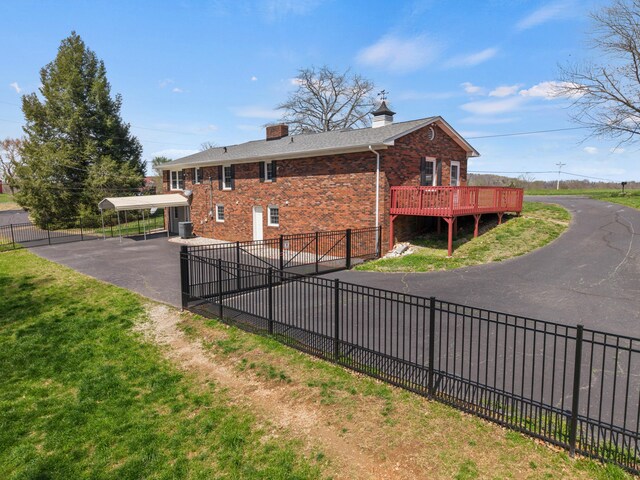 11 Hominy Hill Rd, Nancy, KY 42544 - back of property featuring a fenced backyard, a chimney, brick siding, driveway, and a carport