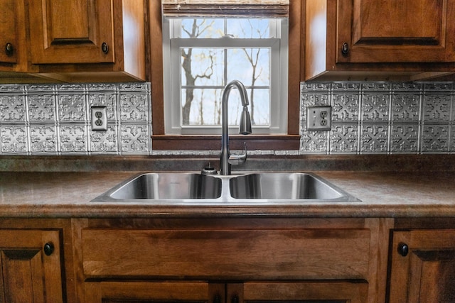11 Hominy Hill Rd, Nancy, KY 42544 - kitchen with brown cabinetry, a sink, backsplash, and dark countertops