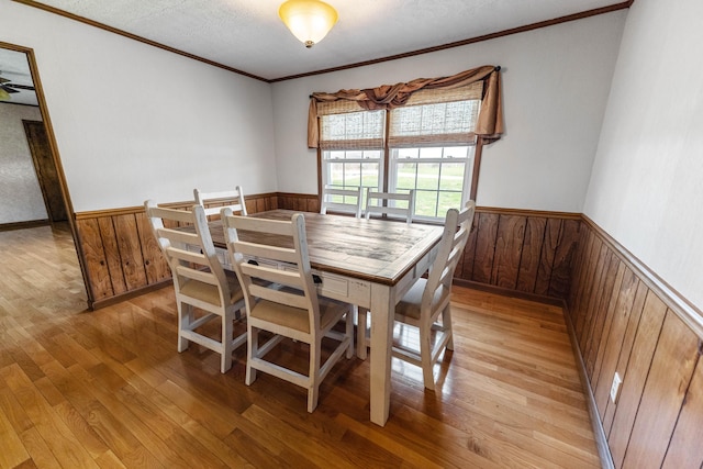 11 Hominy Hill Rd, Nancy, KY 42544 - dining space featuring light wood-type flooring, ornamental molding, wainscoting, and a textured ceiling