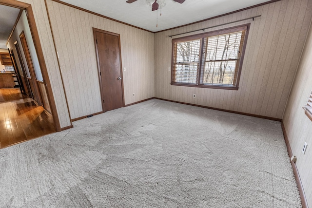 11 Hominy Hill Rd, Nancy, KY 42544 - carpeted spare room with a ceiling fan, baseboards, wood walls, and ornamental molding