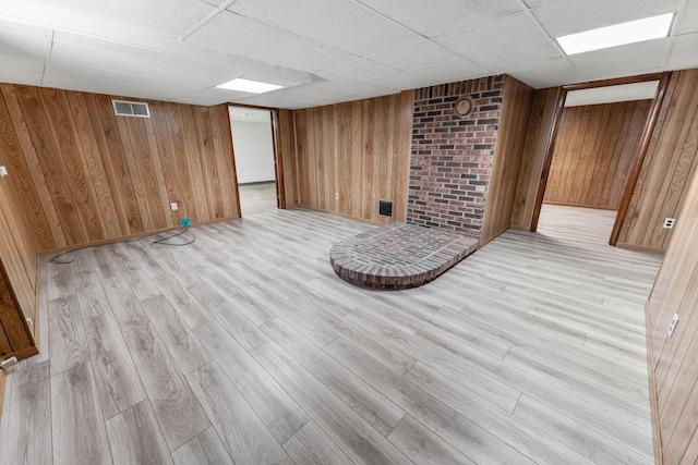 11 Hominy Hill Rd, Nancy, KY 42544 - finished below grade area with wooden walls, visible vents, a paneled ceiling, and light wood-style flooring