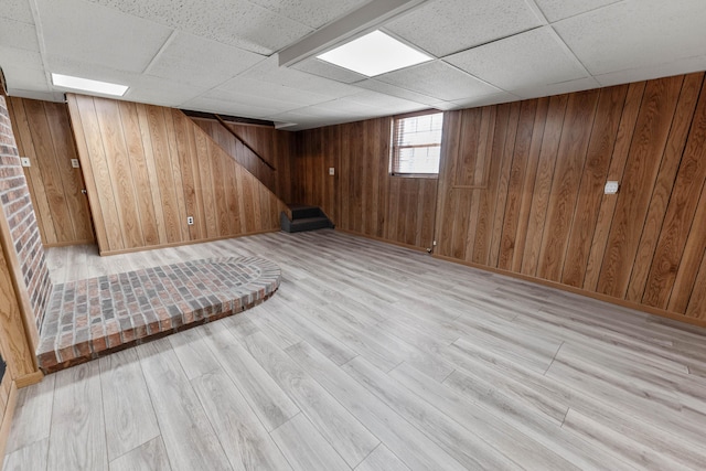11 Hominy Hill Rd, Nancy, KY 42544 - below grade area with baseboards, wood walls, a drop ceiling, and wood finished floors
